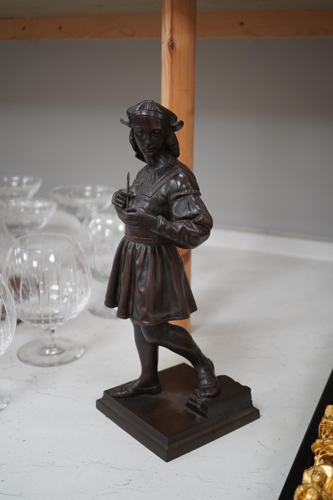 A cast iron figure of a scribe, with bronzed patina, 33cm high. Condition - good